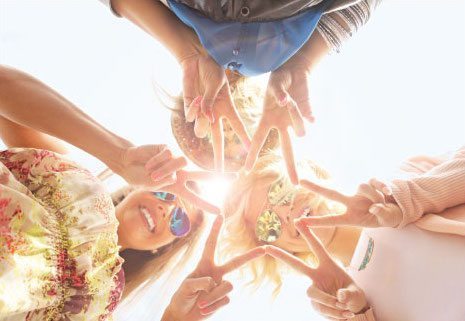 a group of children holding hands outside.