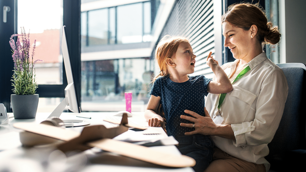 a child sitting in a working mothers lap